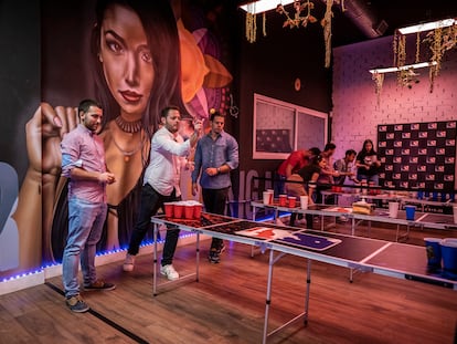 Varios grupos de jóvenes juegan al 'beer pong' en el local de la calle Doctor Fourquet, 20 de Madrid este sábado.