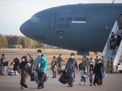 Evacuees from Afghanistan disembark from a U.S. airforce plane at the Naval Station in Rota, southern Spain, Tuesday Aug 31, 2021. The United States completed its withdrawal from Afghanistan late Monday, ending America's longest war. (AP Photo/ Marcos Moreno)