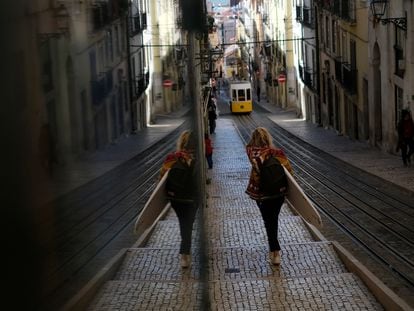 Una mujer transporta una tabla de surf por el centro de Lisboa el pasado 5 de noviembre.