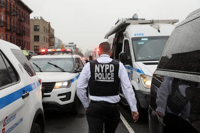 A police officer works near the scene of the shooting at a Brooklyn subway station.