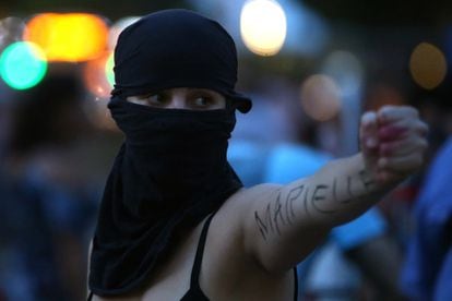 A protester shows her arm on which the word Marielle is read in reference to the murder of the Rio councilor.