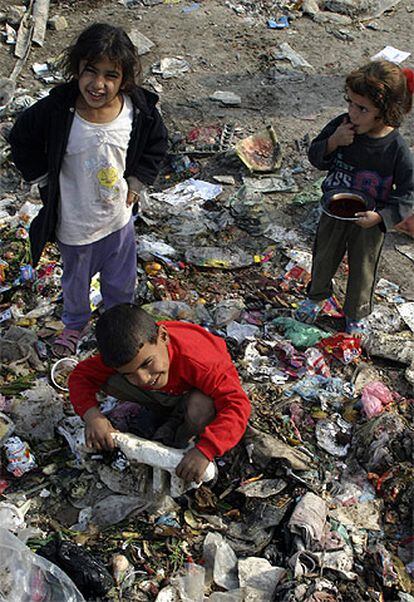 Unos niños rebuscan entre una pila de basura en Sadr City, uno de los barrios más pobres de todo Bagdad.