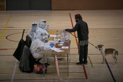 Un hombre deposita su voto en el polideportivo municipal España Industrial de Barcelona.