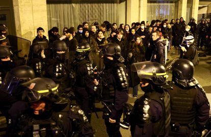 Young people are surrounded by police during a protest in Paris on Monday.