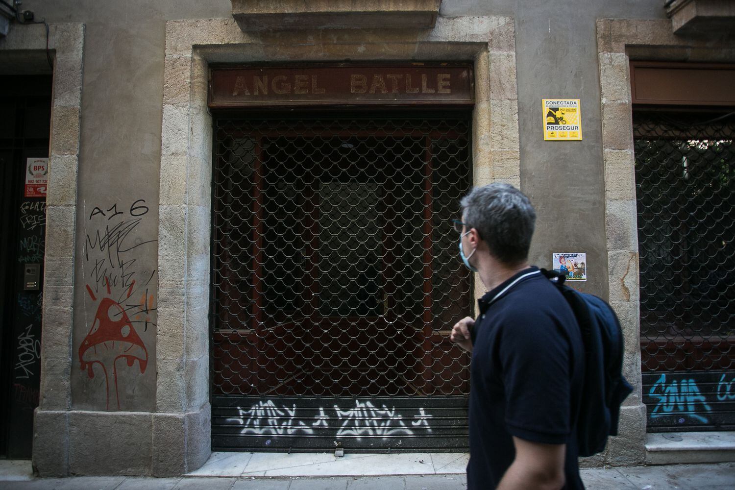 Un hombre pasa por delante de la librería Àngel Batlle cerrada, este jueves en Barcelona.