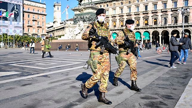 Italian soldiers wearing sanitary masks patrol Duomo square, in downtown Milan, Italy, Monday, Feb. 24, 2020. At least 190 people in Italy’s north have tested positive for the COVID-19 virus and four people have died, including an 84-year-old man who died overnight in Bergamo, the Lombardy regional government reported. (Claudio Furlan/Lapresse via AP)