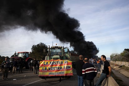 Una columna de humo se eleva en la autopista AP-7 en Pontós (Girona), durante el corte de los payeses este miércoles.