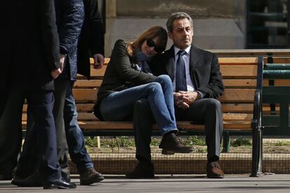 El expresidente Sarkozy y su mujer, Carla Bruni, sentados en un banco tras votar en la primer ronda de las elecciones municipales en París.