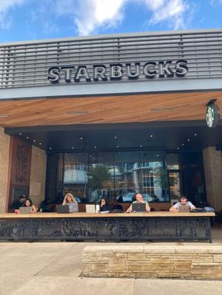 A group of young people work on the terrace of a Starbucks in Domain, one of Austin's new neighborhoods, grown up in the heat of the technological boom.