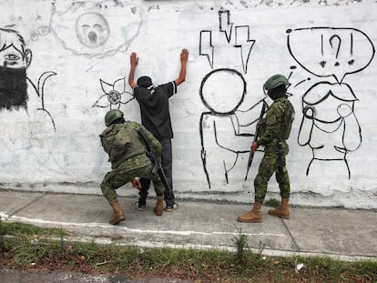 A soldier conducts a search at a military checkpoint in Quito, Ecuador