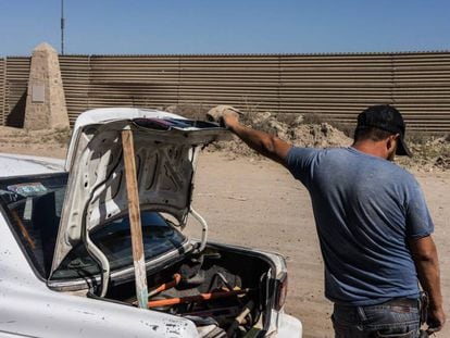 Un hombre frente al muro entre México y Estados Unidos.