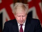 Britain's Prime Minister Boris Johnson speaks during a news conference in response to the ongoing situation with the coronavirus (COVID-19) pandemic, inside 10 Downing Street, London, Saturday, Dec. 19, 2020. Johnson says Christmas gatherings can’t go ahead and non-essential shops must close in London and much of southern England as he imposed a new, higher level of coronavirus restrictions to curb rapidly spreading infections. (Toby Melville/Pool Photo via AP)