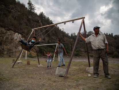 Francisco Castro juega con sus hijos en la ladera del volcán Popocatépetl en Xalitzintla, Puebla.