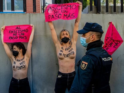 EDS NOTE: NUDITY - Members of feminist group FEMEN protest with their bare chest reading "No vote neither permission to fascism" raise a banner reading "Not another step to fascism"in front of the poll station where the far right party Vox candidate Rocio Monasterio will vote during the regional election for a new regional assembly in Madrid, Spain, Tuesday, May 4, 2021. Over 5 million Madrid residents are voting Tuesday for a new regional assembly in an election that tests the depths of resistance to lockdown measures and the divide between left and right-wing parties. (AP Photo/Manu Fernandez)