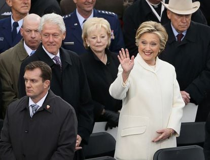 Former Secretary of State Hillary Clinton waves as she arrives with her husband former President Bill Clinton during inauguration ceremonies swearing in Donald Trump