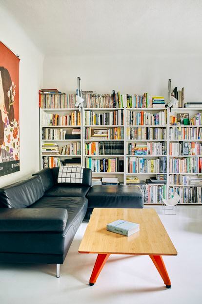 The living room, with two balconies facing Bravo Murillo Street, and, in the back, a large bookcase takes up the entire wall.  The floor of the house was painted white to unify the space.  “It's a hobby that my mother and I share, painting the floors white,” says Francesca Heathcote Sapey.