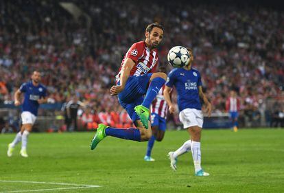 El jugador Juanfran, del Atlético Madrid, intenta controlar el balón.