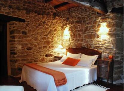la habitación Lúa Chea (luna llena), con paredes de piedra vista.