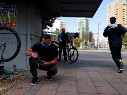 Migrantes venezolanos reparan bicicletas en las calles de Quito, Ecuador.