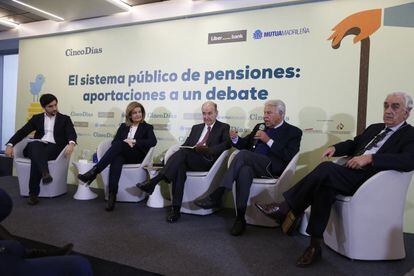Los participantes en el debate escuchan a Felipe González.