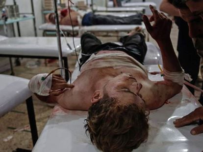 Dos hombres tratan de comunicarse con un herido en un hospital improvisado de Duma, a las afueras de Damasco, el pasado 26 de septiembre.