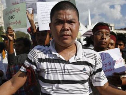 Un hombre lleva un cartel en una protesta en Rangún, la capital de Myanmar.