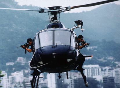 Dos tiradores del CORE apoyan la operación terrestre desde un helicóptero.