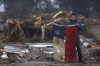 Bruno Salvador, un artesano, muestra la bandera chilena tras el terremoto en Pelluhe (Chile).