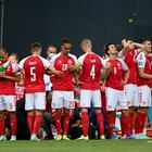 Denmark players make a wall around teammate Christian Eriksen being assisted by medics during the Euro 2020 soccer championship group B match between Denmark and Finland at Parken Stadium in Copenhagen, Saturday, June 12, 2021. (Stuart Franklin/Pool via AP)