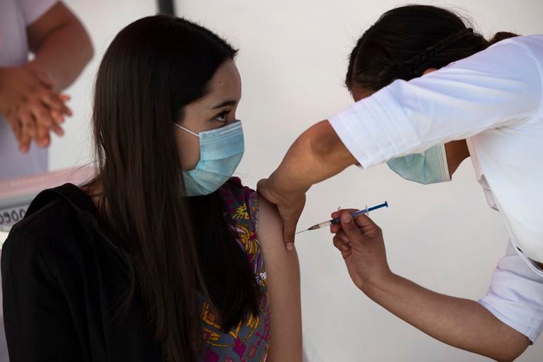 A healthcare provider receives the coronavirus vaccine in Mexico City.