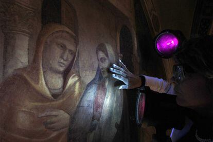 Un restaurador utiliza luz ultravioleta para ver con detalle las pinturas de Giotto en la capilla Peruzzi de la basílica florentina de la Santa Cruz.