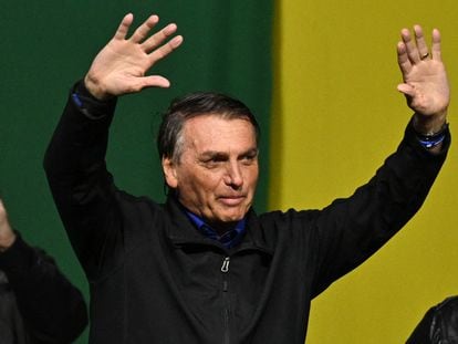 Brazilian President and re-election candidate Jair Bolsonaro greets his supporters during a rally in Santos, Sao Paulo state, Brazil, on September 27 2022. - Brazil entered the final stretch of the presidential campaign, a high voltage electoral duel between archrivals Jair Bolsonaro and Luiz In�cio Lula da Silva that, according to polls, could be defined already in the first round on October 2 in favor of the former president. (Photo by NELSON ALMEIDA / AFP)