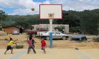 Niños jugando un partido en la cancha principal de Río Venado. Esta pista funciona también como plaza principal del pueblo, en el que viven unos 400 indígenas triquis. Por lo general, los niños suelen juegar descalzos, igual que suelen caminar sin calzar por los caminos de tierra del pueblo.