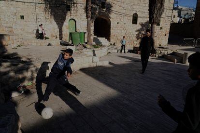 Palestinian children play in Hebron's old quarter.  
