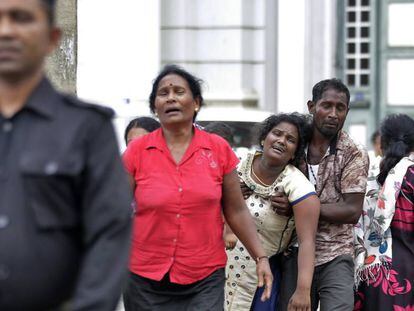 Familiares de las víctimas, cerca de una morgue, este domingo en Colombo.