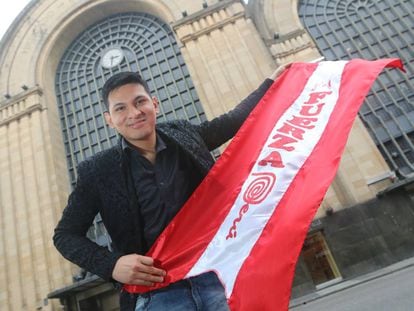 Anthony Escalante posa con la bandera de Perú frente al edificio del Abasto.