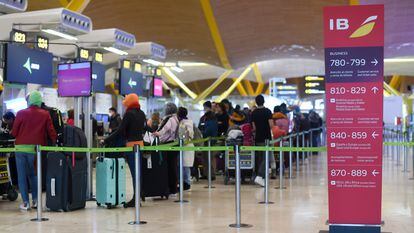 Varias personas esperan para embarcar y facturar en la zona de salidas de la Terminal 4 del Aeropuerto Madrid-Barajas Adolfo Suárez, este sábado.