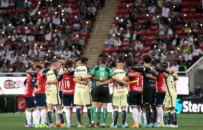 Jugadores de las Chivas, del América y los árbitros se abrazan para pedir paz en el fútbol mexicano.