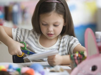 Una ni&ntilde;a hace manualidades en el colegio. 