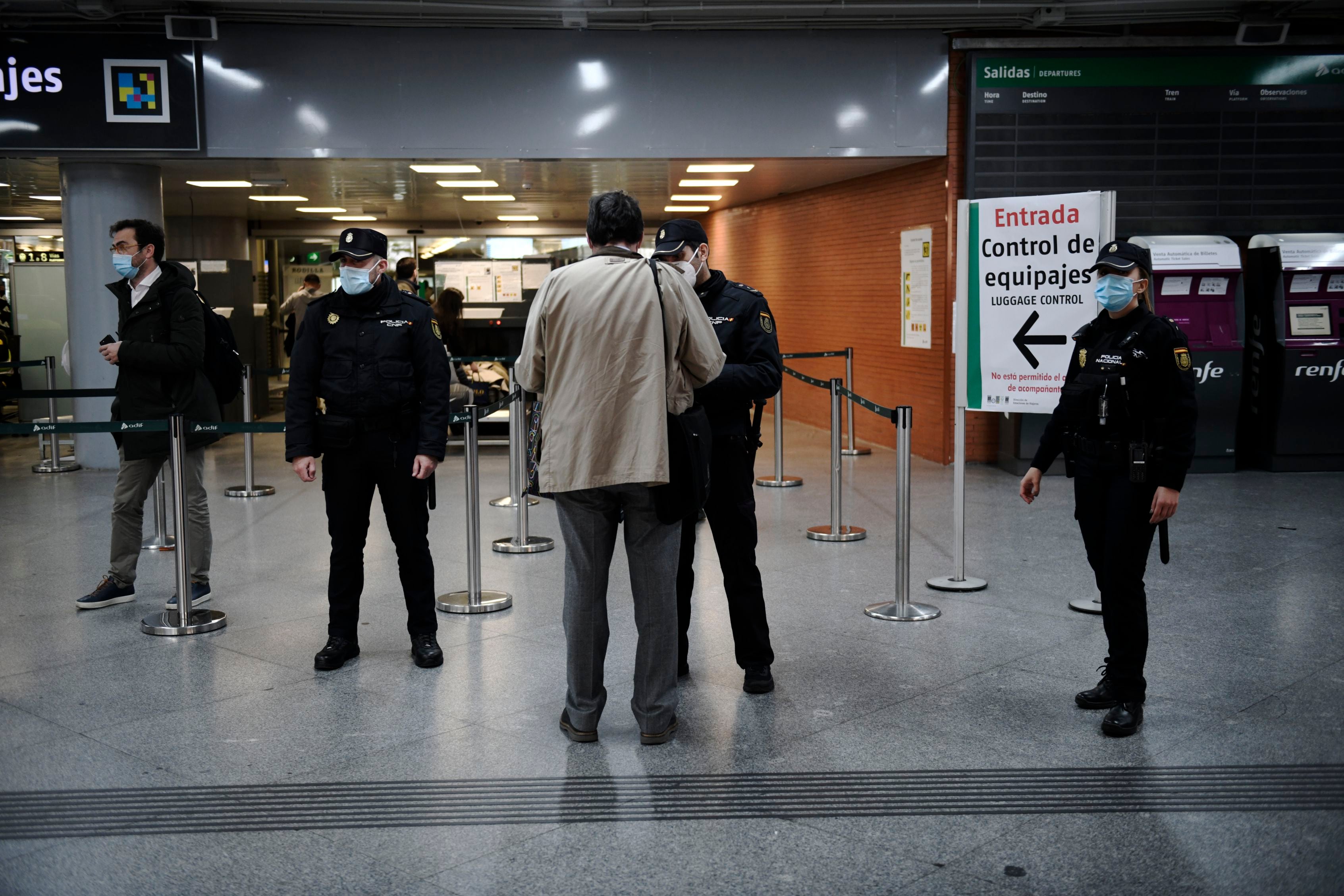 Varios agentes de la Policía Nacional controlan la documentación de los pasajeros en la estación de Atocha, en Madrid, el pasado jueves.