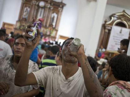 Un hombre bebe ron en una iglesia de Managua.