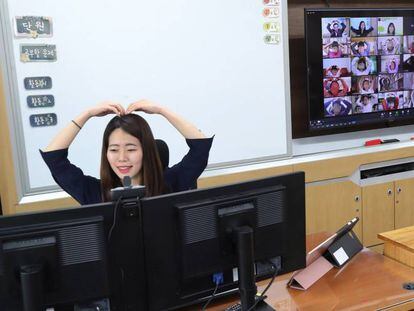 Una profesora saluda a sus alumnos antes de impartir una clase a distancia.