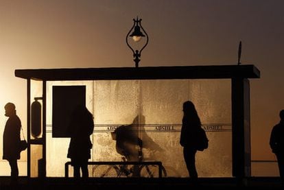 Irlandeses aguardan al autobús a primera hora de la mañana el pasado viernes, en la parada de Howth, para ir a trabajar
a Dublín.