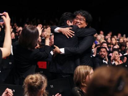 El director coreano Bong Joon-ho, felicitado por Song Kang-ho, el protagonista de su película, 'Parasite', con la que ganó la Palma de Oro.