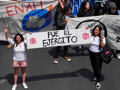 Dos mujeres llevan un letrero que dice "Fue el ejército", una consigna que hace eco de los carteles del lunes pasado en la marcha por la memoria de los ocho años de la desaparición de los estudiantes de Ayotzinapa.