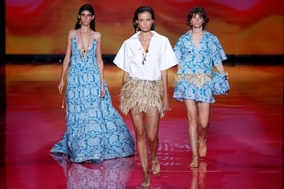 Three models parade with creations by designer Pedro del Hierro, during the first day of the 76th edition of the Mercedes Benz Fashion Week Madrid catwalk.