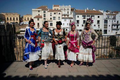 Mujeres vestidas con trajes tradicionales posan para los turistas durante el Día Mundial del Turismo, en Ronda.
