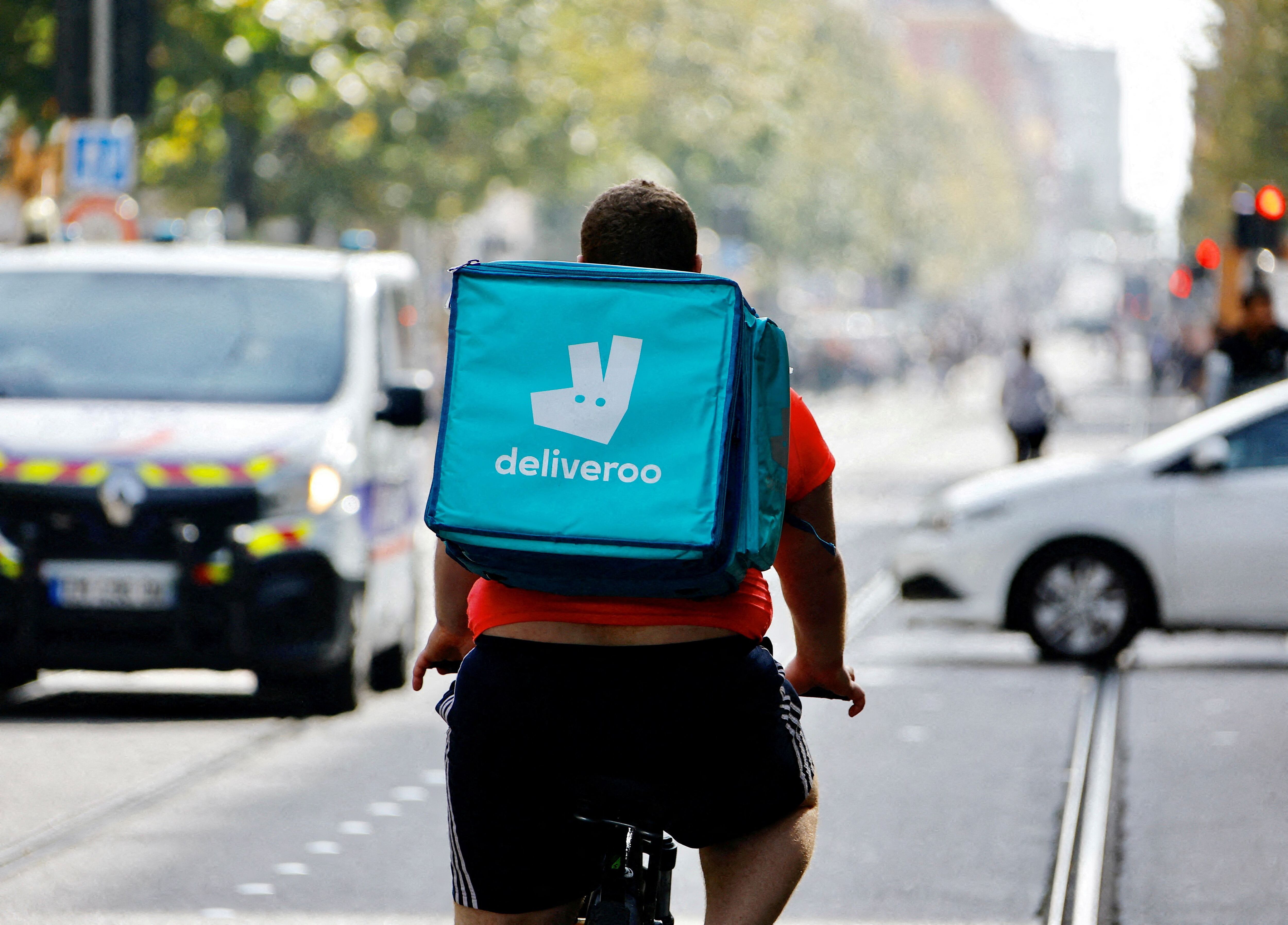 FILE PHOTO: A delivery worker with a backpack of Deliveroo rides a bike in Nice, France, October 25, 2022. REUTERS/Eric Gaillard/File Photo