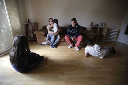 Aroa (a la izquierda) y Laura, con los hijos de la primera, en el salón de la casa que okupan.