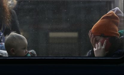 A woman and a child, sitting on a train leaving the Central Station of Lviv (Ukraine) bound for Poland, on March 2.